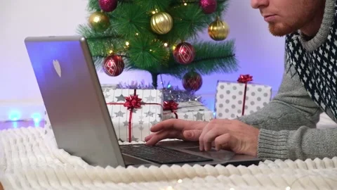 Man with laptop working, studying remotely new year 2023, Christmas. Remote work Stock Footage 221867926