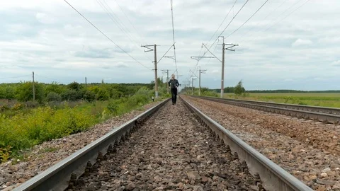A man with laptops in his hands, runs on rails. Video stock 78153822