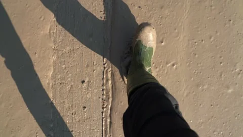 A man in large dirty rubber boots is standing in a dirty spring puddle Stock Footage 152775015