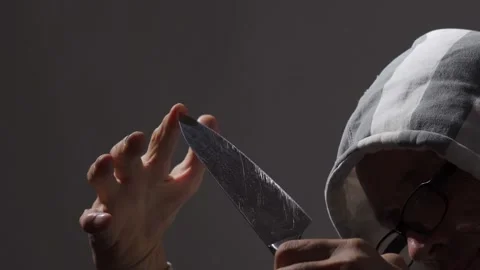 A man with a large kitchen knife. Threaten or intimidate Stock Footage 246027016