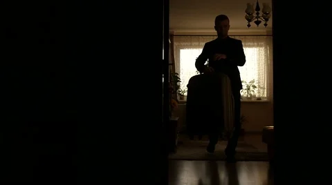 Man with large trunk going away from home dolly shot slow motion Stock Footage 59913025