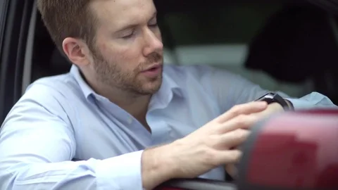A Man Late for Work is Stuck Waiting in Traffic Jam, Impatient Looking at Watch Stock Footage
