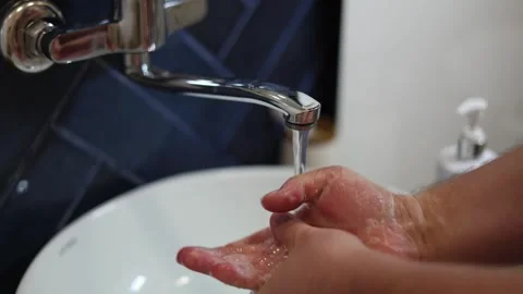 Man lathering his hands with soap and washing them in white ceramic sink Stock Footage 337832056