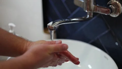 Man lathering his hands with soap and washing them in white ceramic sink Stock Footage 340427478