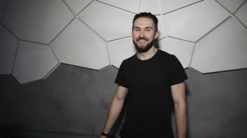 Man is laughing standing at the wall Stock Footage 86255443