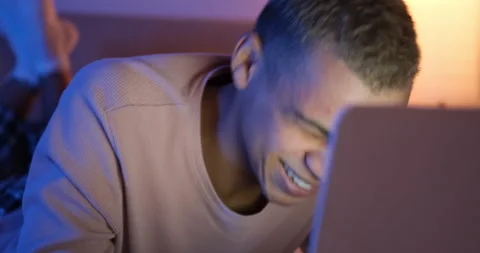 Man laughing using laptop at night Stock Footage 145289593