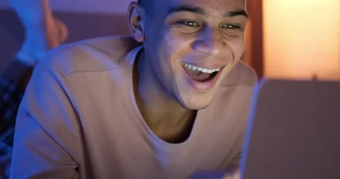 Man laughing using laptop at night Stock Footage 145291177