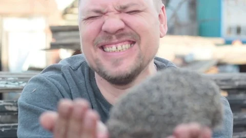 The man laughs when a hedgehog bites his fingers Stock Footage 74947826