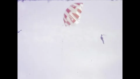 Man launching a kite on a sandy beach in 1970s Stock Footage 313726809