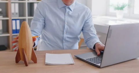 Man Launching Toy Rocket While Working In Office Stock Footage 311556083