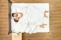 The man lay near a woman on the bed. View from above Photo