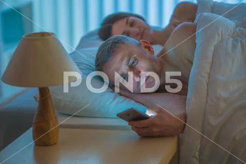 The man lay with woman and phone Stock Photos