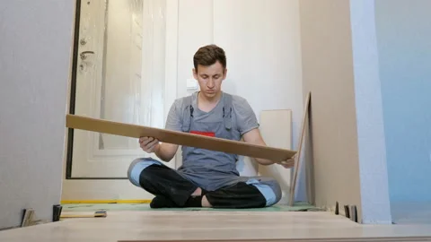 Man layering floor wood planks Stock Footage