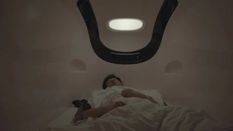 A man is laying in bed with a blanket over his head Video stock 314455435