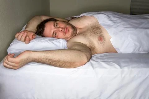 Man laying in bed Foto stock