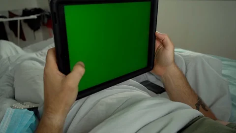 Man laying in bed using tablet Chroma key green screen Stock-Footage 128294242