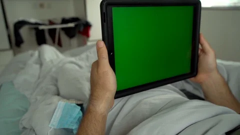 Man laying in bed using tablet Chroma key green screen Stock-Footage 128294264