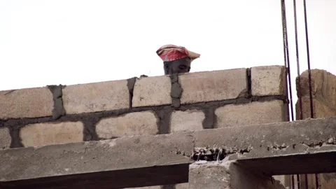Man laying blocks with mortar and trowel Stock Footage 201316459