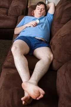 Man laying down on the couch Stock-Fotos