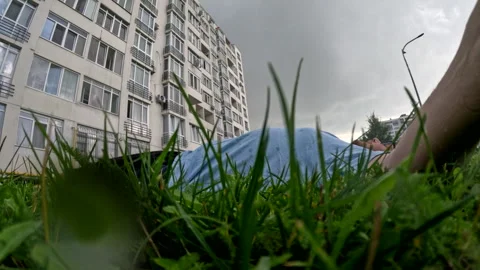 Man laying down in grass under the rain Stock Footage 252362157