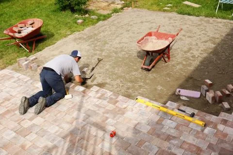 Man laying down paver Stock Photos