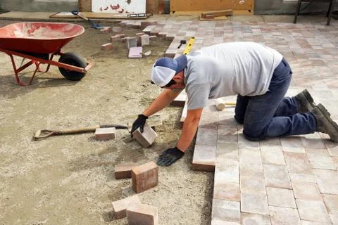 Man laying down paver Stock Photos