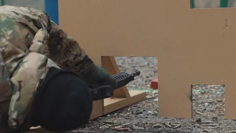 Man Laying on the Ground Shooting AR 15 Rifle from Prone Position 库存影片 142105311
