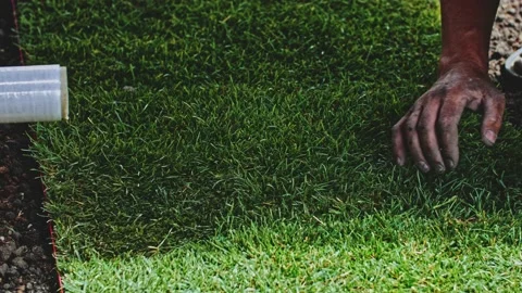 Man Laying Out Rolls Of Sod. Making A Green Grass Lawn. SLOW MOTION. Video stock 140295811