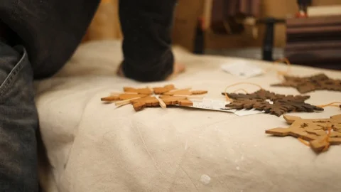 Man laying out snowflakes on table closeup Stock Footage 102045582