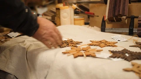Man laying out snowflakes on table closeup Stock Footage 102045586