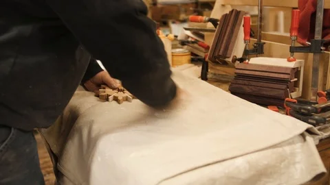 Man laying out snowflakes on table woodworking project Stock Footage 102045590
