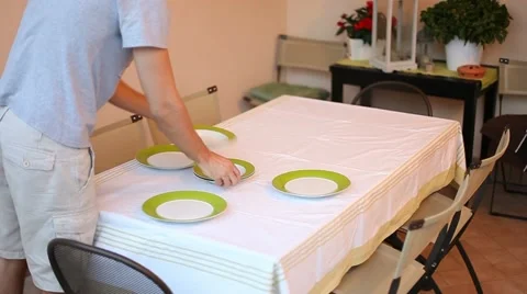 Man laying serve dishes on the table Video stock 11235684