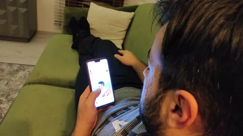 Man Laying on the Sofa and Using Mobile Phone Video stock 143745288