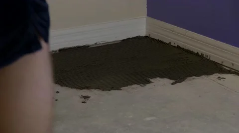 Man lays first tile in bedroom, 4K Stock Footage 59171271