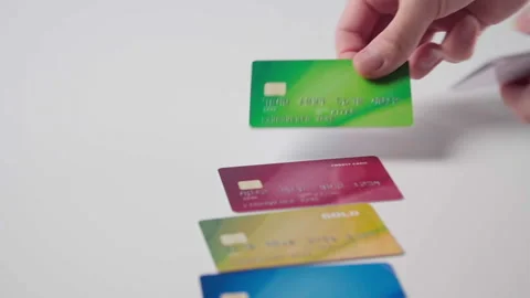 Man lays out multi-colored bank cards on the table. Stock Footage 143909868