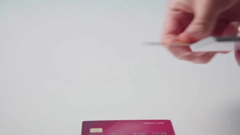 Man lays out in a row multi-colored bank cards on the table Stock Footage 143909863