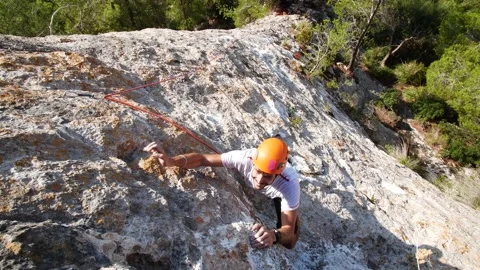 Man lead climbing in wall next to sea 4K 5 Stock Footage 139982276