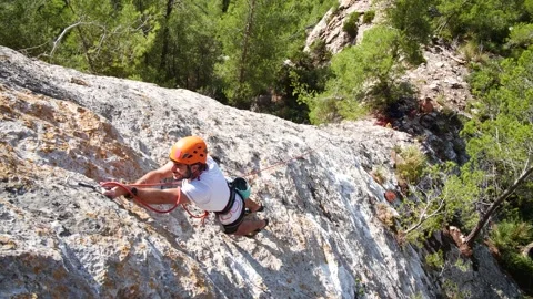 Man lead climbing in wall next to sea 4K 4 Stock Footage 139982289
