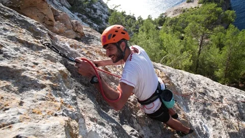 Man lead climbing in wall next to sea 4K 10 Stock Footage 139982432