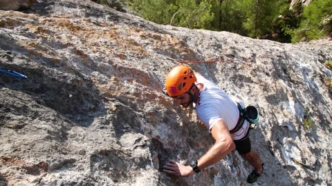Man lead climbing in wall next to sea 4K 9 Stock Footage 139982491