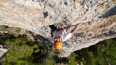 Man lead climbing in wall next to sea 4K 15 Stock Footage 139982553
