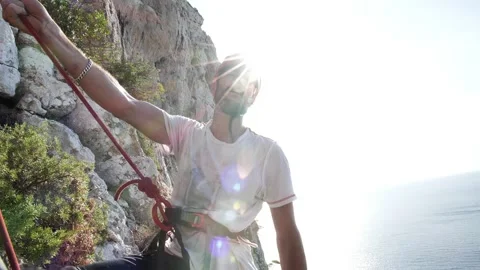 Man lead climbing in wall next to sea 4K 23 Stock Footage 139982622