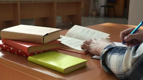 A man leads entries in a notebook sitting at the table in the office Stock Footage 155886796