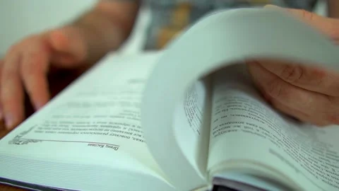 A man leafing through a book Stock Footage 141363688