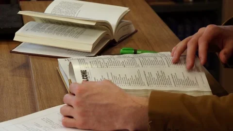 Man leafing through a book Stock Footage 155963016