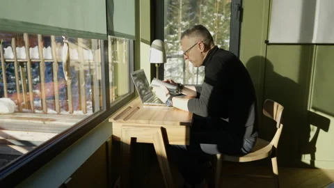 Man leafing through a book at his desk Stock Footage 265103501
