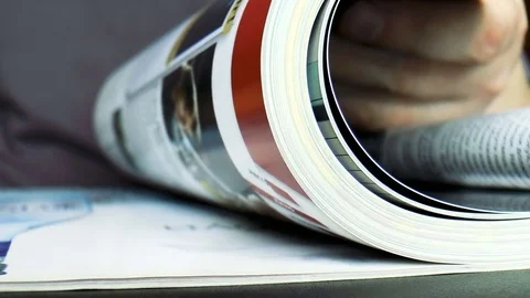 Man leafing through a magazine Stock Footage 79411198