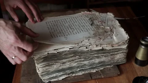 Man leafing through an old book with handwritten text Stock Footage 141753057