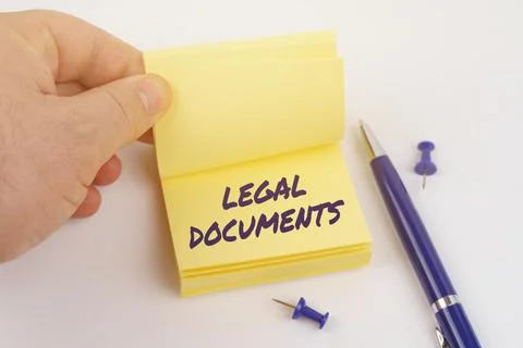 The man is leafing through the stickers, the sheet says - LEGAL DOCUMENTS Stock Photos