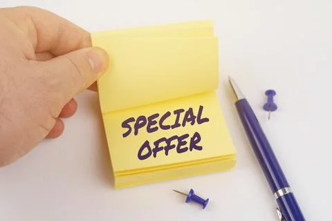 The man is leafing through the stickers, the sheet says - SPECIAL OFFER Stock Photos